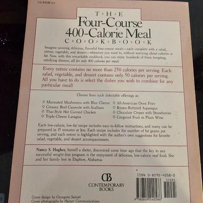 Large stew pot with lid, smaller pot with lid, utensils, and cookbooks