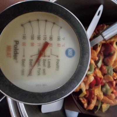 Large stew pot with lid, smaller pot with lid, utensils, and cookbooks