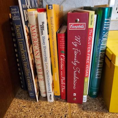 Collection of cookbooks and a large yellow recipe box