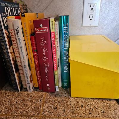 Collection of cookbooks and a large yellow recipe box