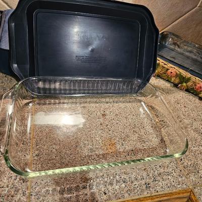 Two Glass Pyrex cake pan with lid and carry case and pyrex pan in basket