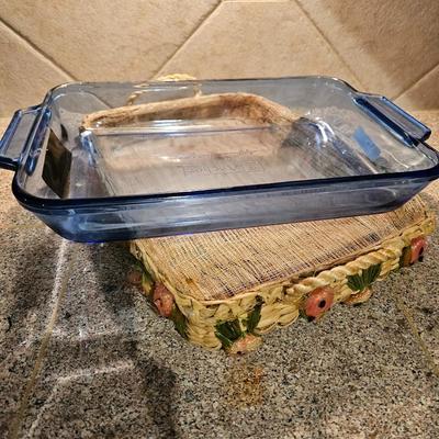 Two Glass Pyrex cake pan with lid and carry case and pyrex pan in basket