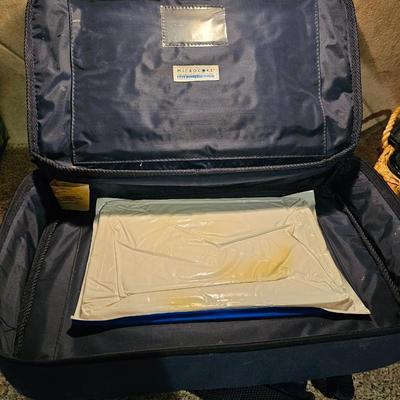 Two Glass Pyrex cake pan with lid and carry case and pyrex pan in basket