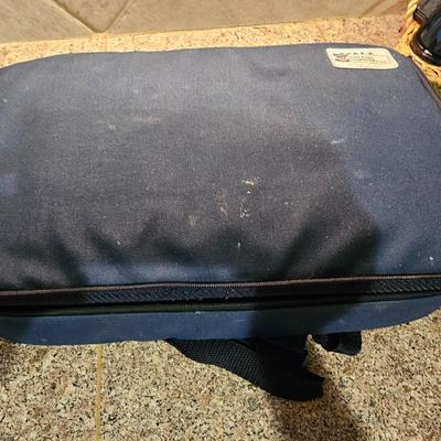 Two Glass Pyrex cake pan with lid and carry case and pyrex pan in basket