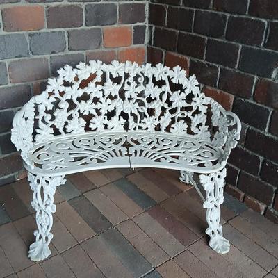 Vintage white cast-iron garden bench with grapevine motif