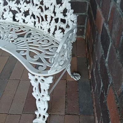 Vintage white cast-iron garden bench with grapevine motif