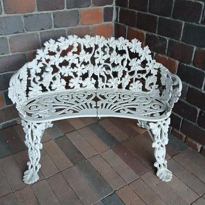 Vintage white cast-iron garden bench with grapevine motif