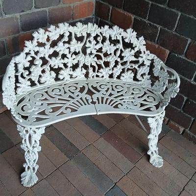 Vintage white cast-iron garden bench with grapevine motif