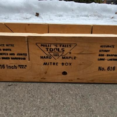 Assortment of hand saws with a wooden Mitre box