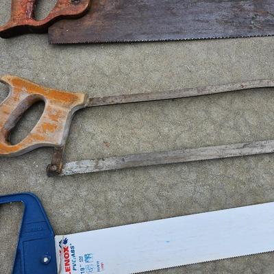Assortment of hand saws with a wooden Mitre box
