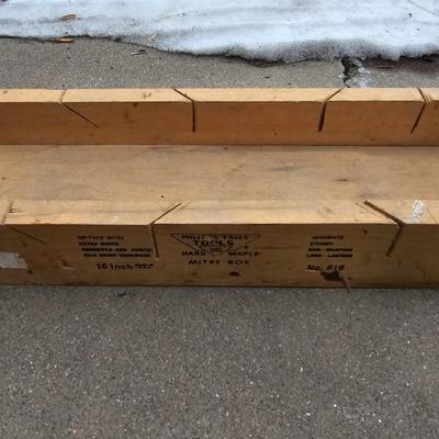 Assortment of hand saws with a wooden Mitre box