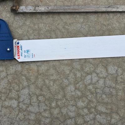 Assortment of hand saws with a wooden Mitre box