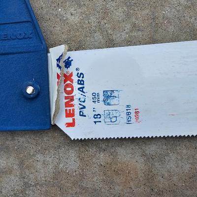 Assortment of hand saws with a wooden Mitre box