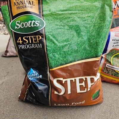 Variety of flowerpots, and partial bags of lawn car and fertilizer