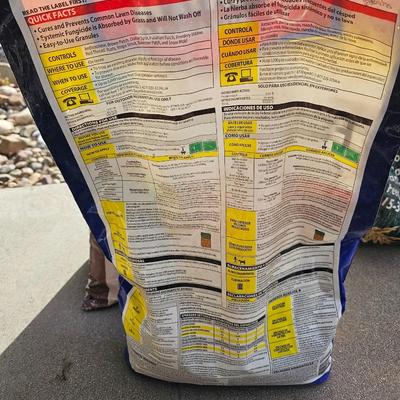 Variety of flowerpots, and partial bags of lawn car and fertilizer