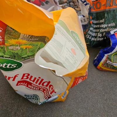 Variety of flowerpots, and partial bags of lawn car and fertilizer