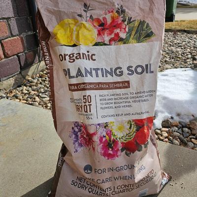 Variety of flowerpots, and partial bags of lawn car and fertilizer