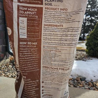 Variety of flowerpots, and partial bags of lawn car and fertilizer