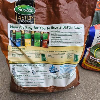 Variety of flowerpots, and partial bags of lawn car and fertilizer