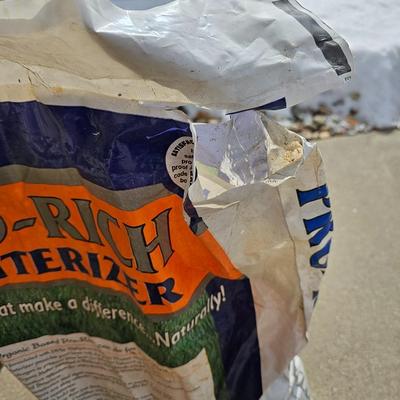 Variety of flowerpots, and partial bags of lawn car and fertilizer