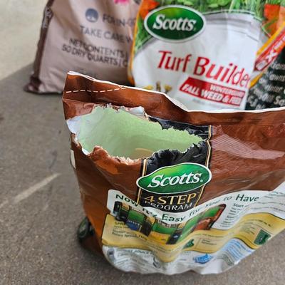 Variety of flowerpots, and partial bags of lawn car and fertilizer