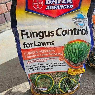 Variety of flowerpots, and partial bags of lawn car and fertilizer