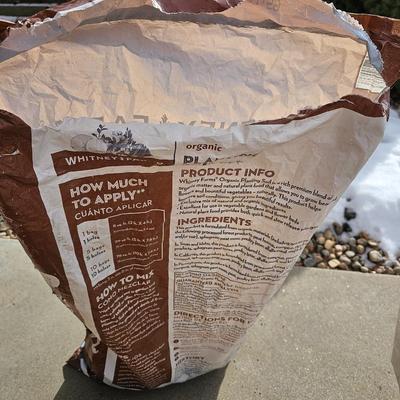 Variety of flowerpots, and partial bags of lawn car and fertilizer