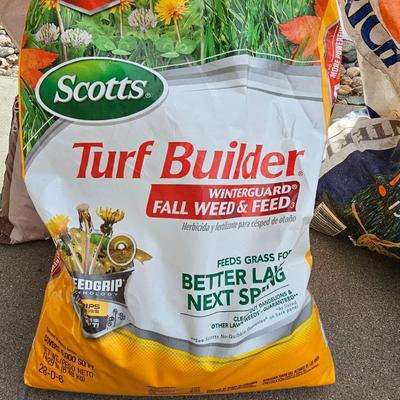 Variety of flowerpots, and partial bags of lawn car and fertilizer