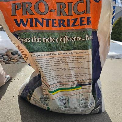 Variety of flowerpots, and partial bags of lawn car and fertilizer