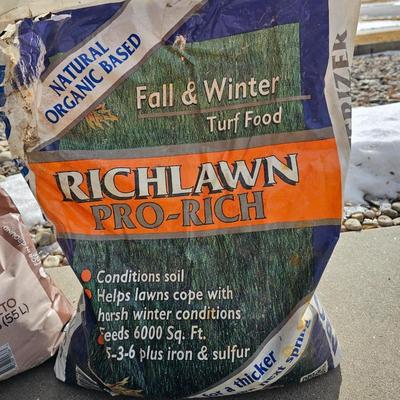 Variety of flowerpots, and partial bags of lawn car and fertilizer