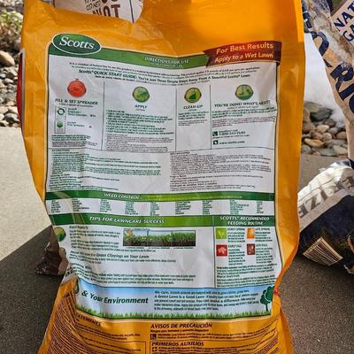 Variety of flowerpots, and partial bags of lawn car and fertilizer