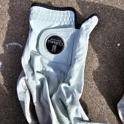 Three new boxes of golf balls and two pair of lightly used gloves