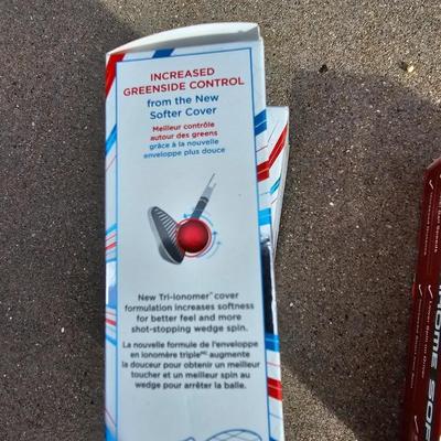 Three new boxes of golf balls and two pair of lightly used gloves