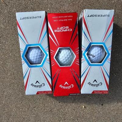 Three new boxes of golf balls and two pair of lightly used gloves
