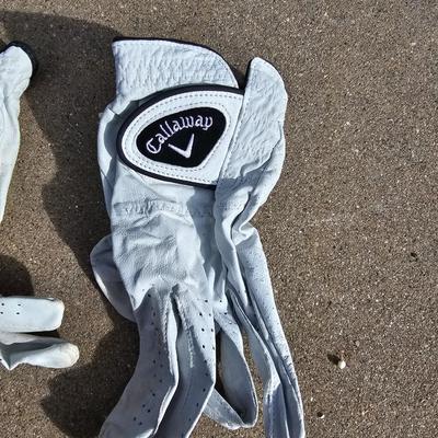 Three new boxes of golf balls and two pair of lightly used gloves