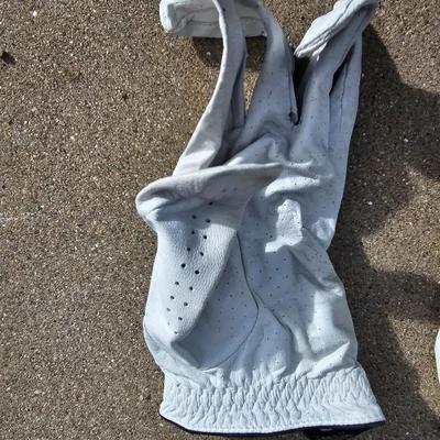 Three new boxes of golf balls and two pair of lightly used gloves