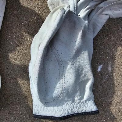 Three new boxes of golf balls and two pair of lightly used gloves