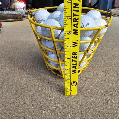 Golf balls in heavy metal golf ball range basket 1 of 4