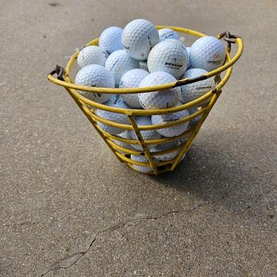 Golf balls in heavy metal golf ball range basket 1 of 4