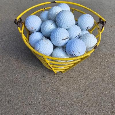 Golf balls in heavy metal golf ball range basket 1 of 4