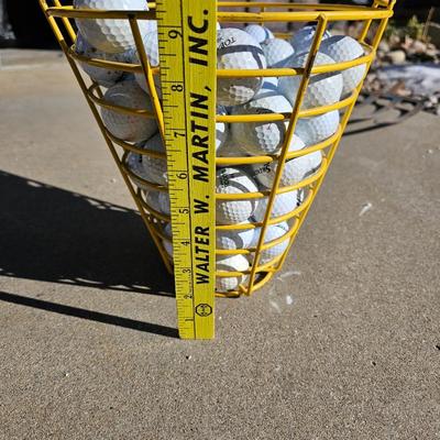 Golf balls in heavy metal golf ball range basket 3 of 4