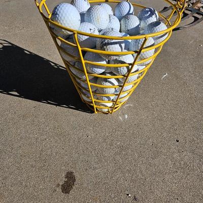 Golf balls in heavy metal golf ball range basket 3 of 4