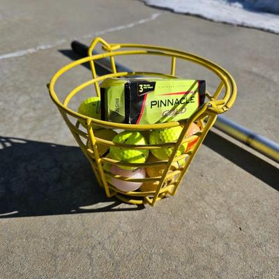 Colored Golf balls in smaller heavy metal golf ball range basket with a golf ball grabber