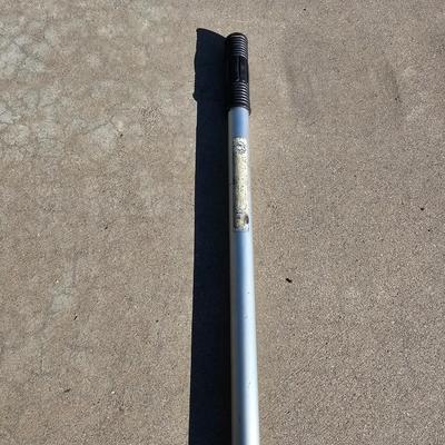 Colored Golf balls in smaller heavy metal golf ball range basket with a golf ball grabber