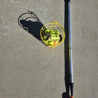 Colored Golf balls in smaller heavy metal golf ball range basket with a golf ball grabber