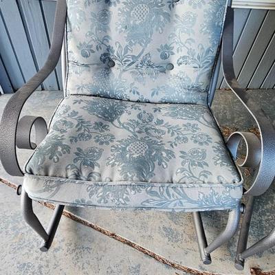 Two metal framed -Grey outdoor rocking chairs with wooden table