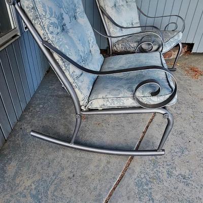 Two metal framed -Grey outdoor rocking chairs with wooden table