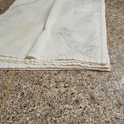 Vintage embroidered kitchen linens and a Royal eight-inch expandable trivet