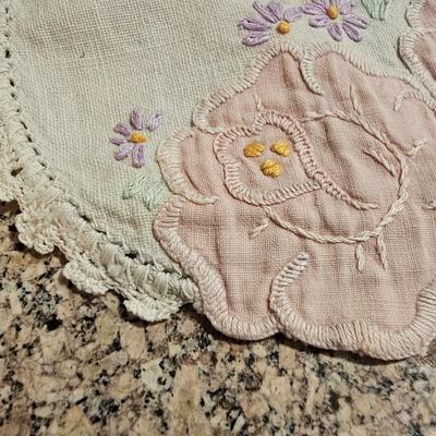 Vintage embroidered kitchen linens and a Royal eight-inch expandable trivet