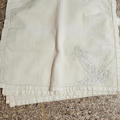 Vintage embroidered kitchen linens and a Royal eight-inch expandable trivet